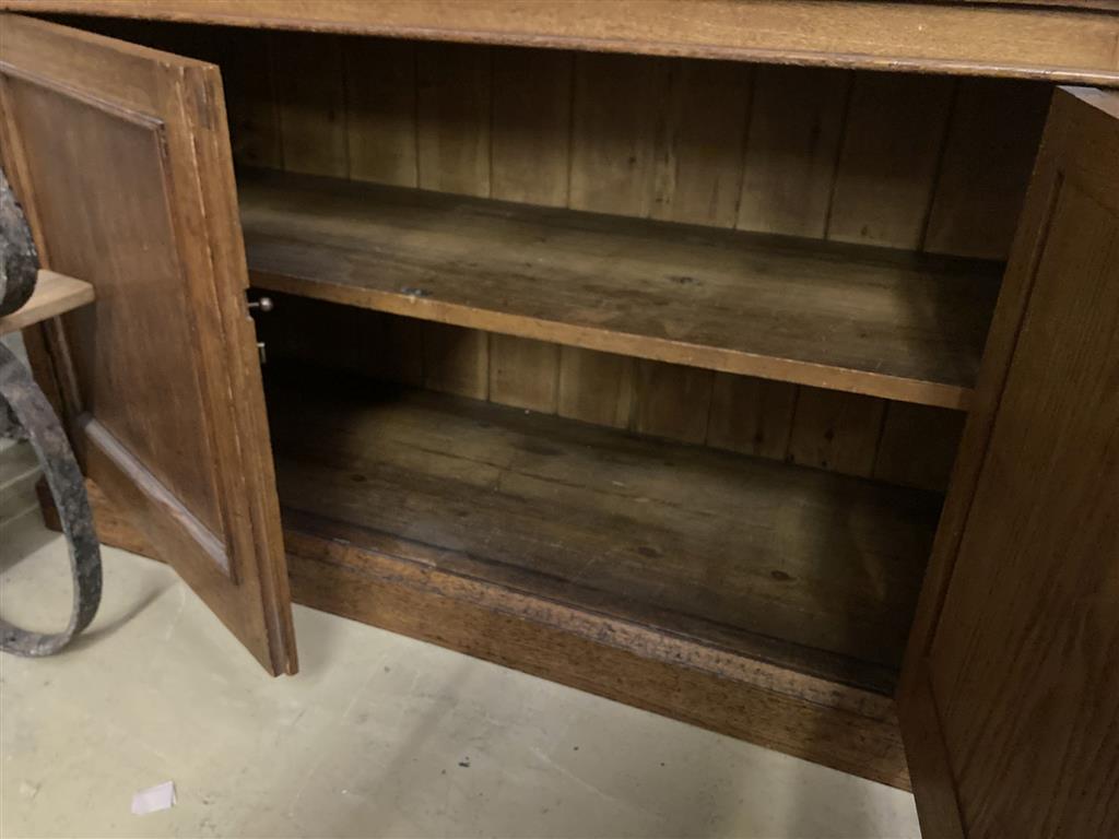 A late 19th century panelled oak library bookcase, length 118cm, depth 47cm, height 223cm